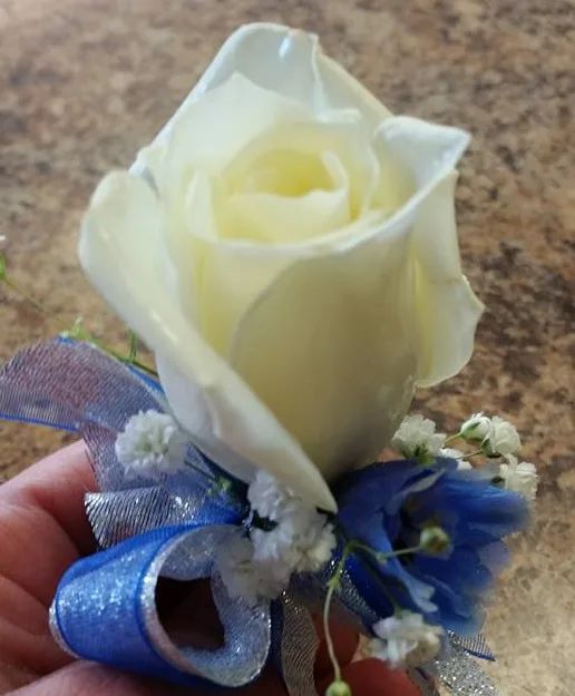 White rose, royal blue delph Boutonniere