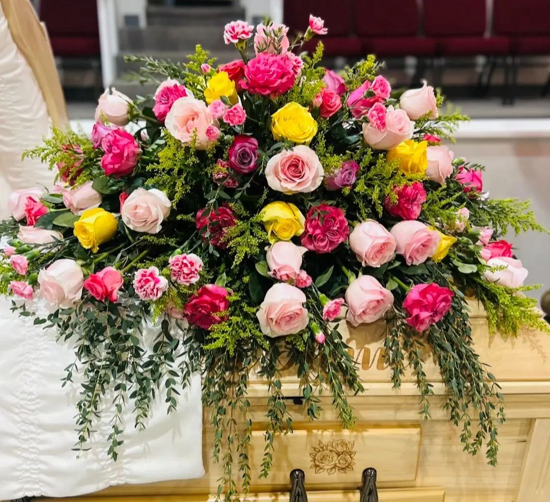 Reds and yellows casket spray
