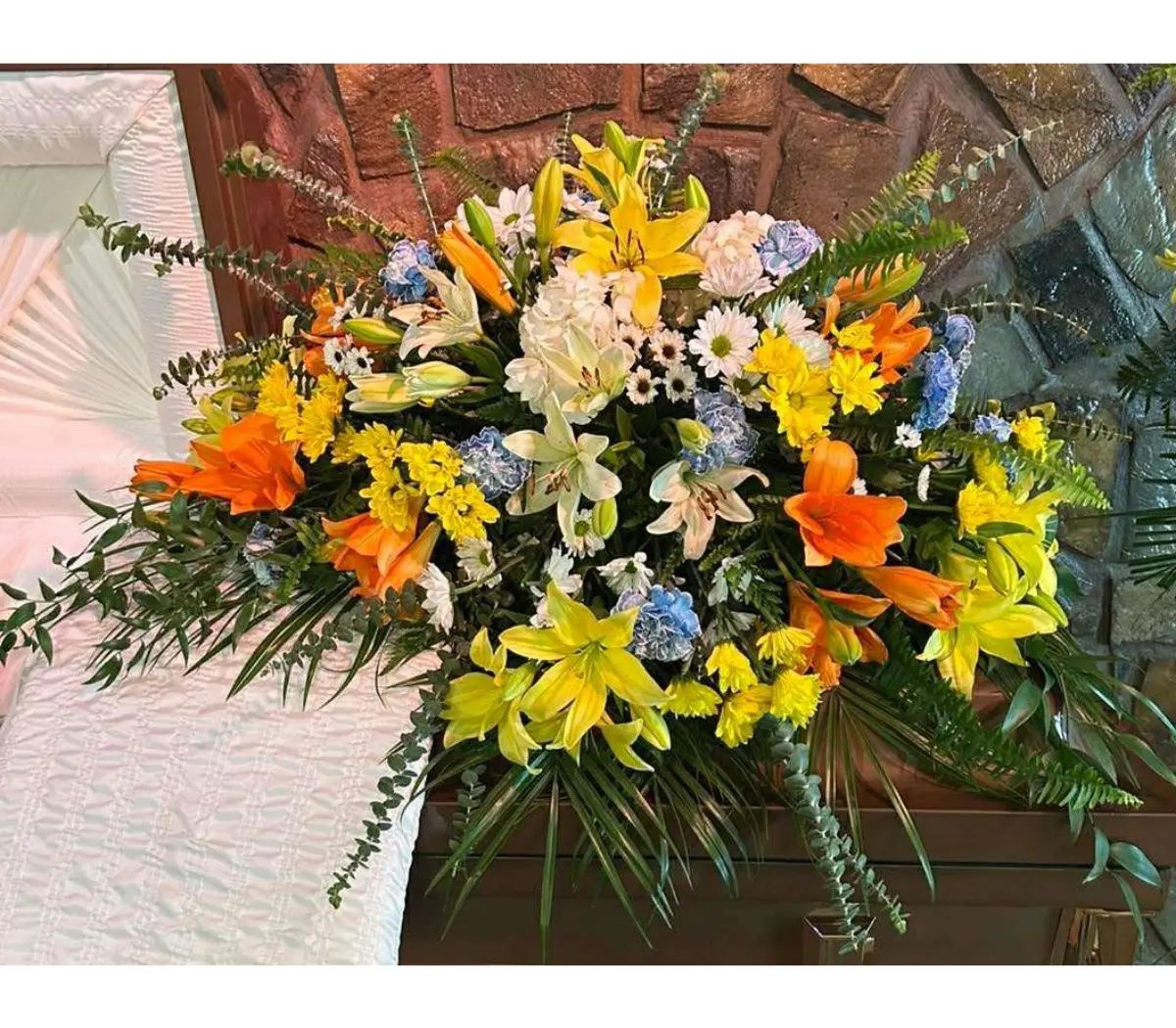 Sunshine and blues casket spray