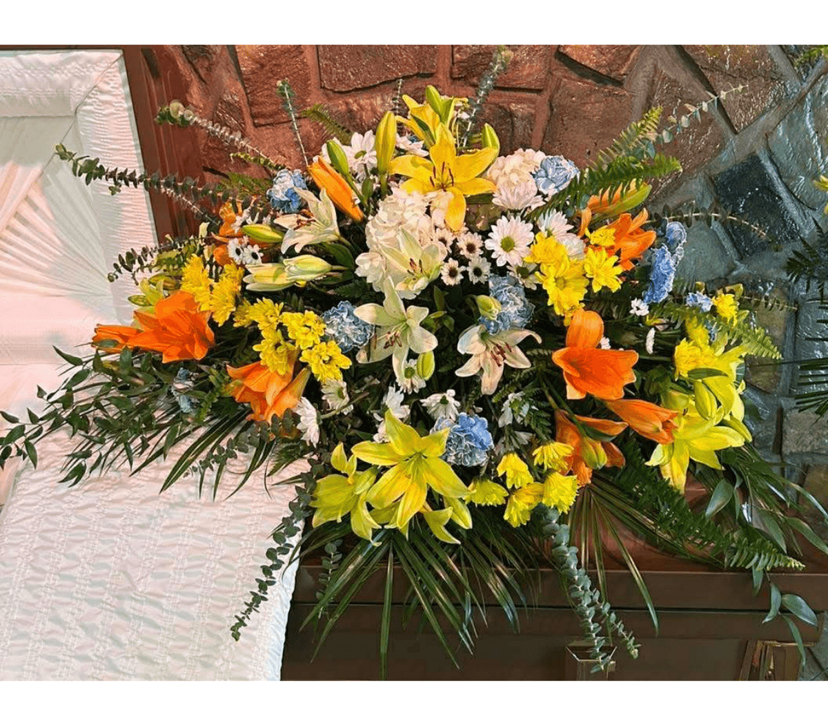 Sunshine and blues casket spray