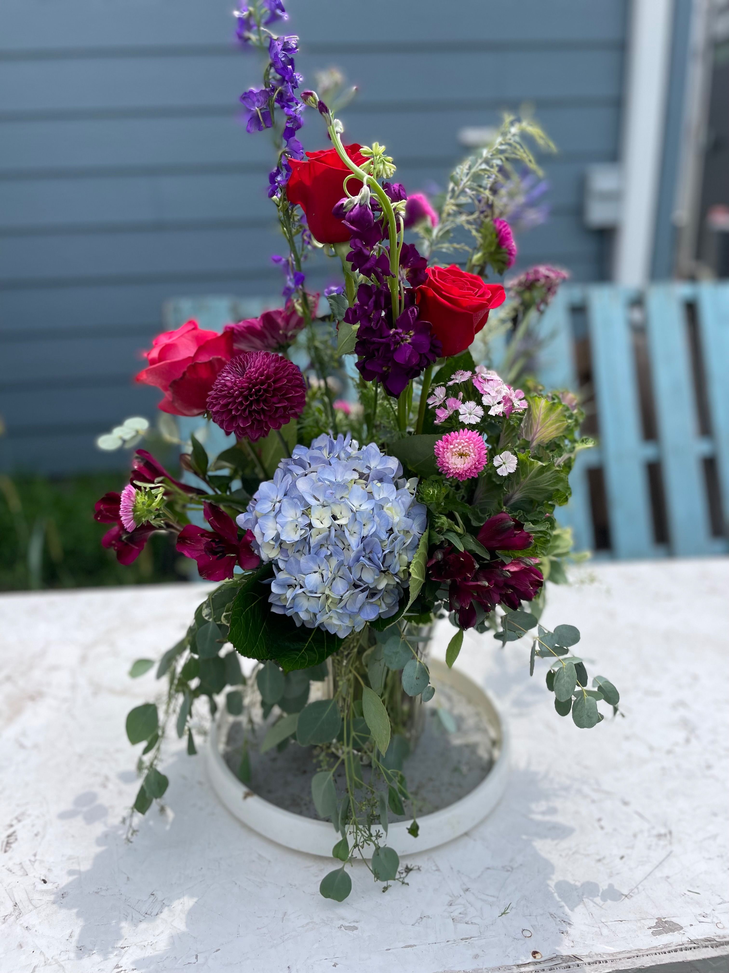 Red roses and hydrangea vase