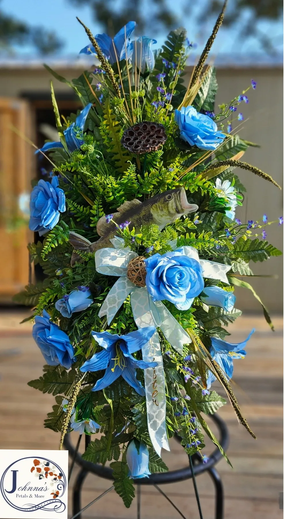 Bass and the color Blue Silk spray on easel with bass and variety of blue themed flowers Bass and the color Blue Silk spray on easel with bass and variety of blue themed flowers