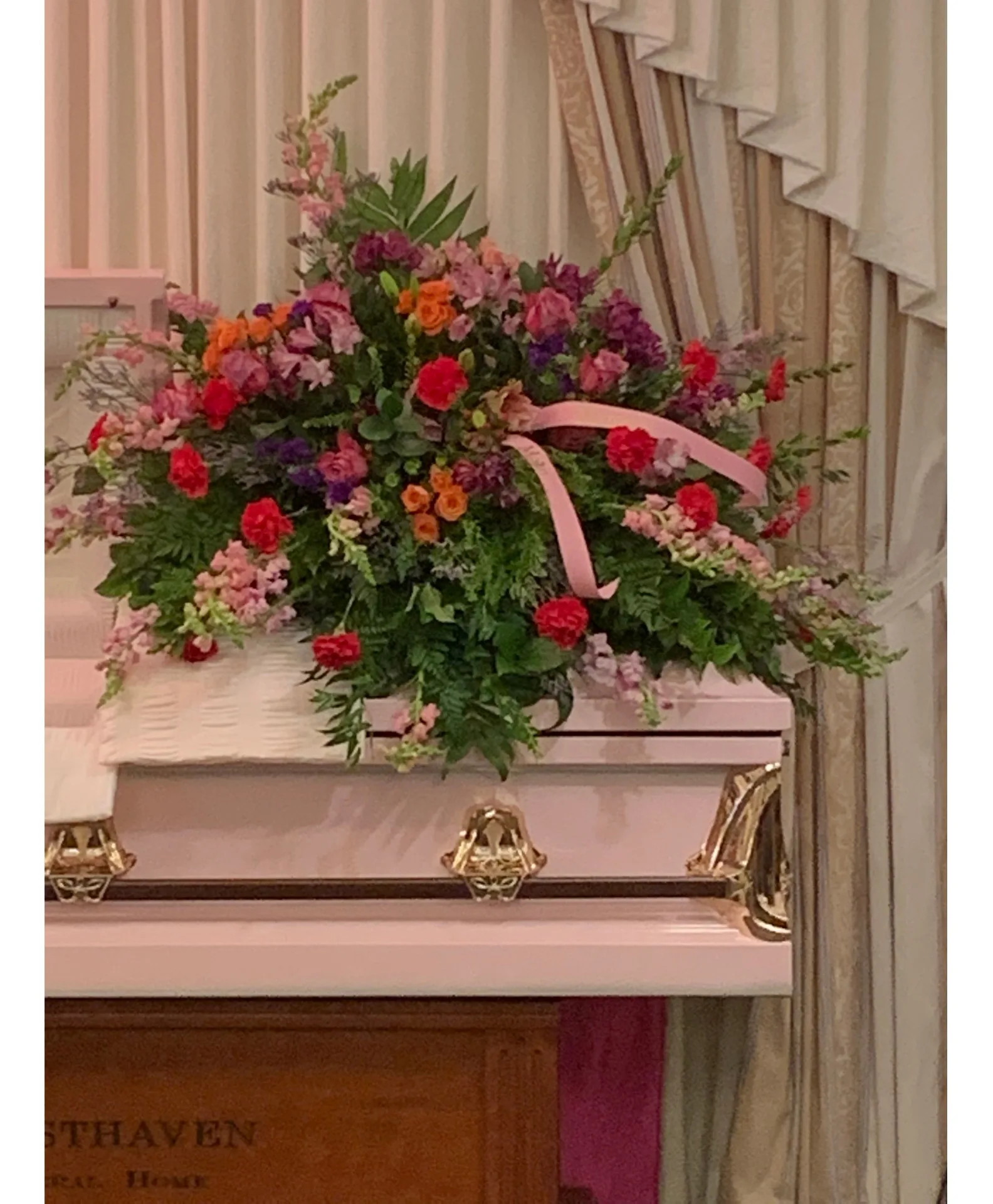 Ladies Top Choice Casket Spray Shown in pinks Ladies Top Choice Casket Spray Shown in pinks